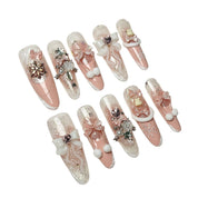 Blush Snow Bows pink winter press-on nails with 3D bows, snowflakes and pearls by Poppy Nails