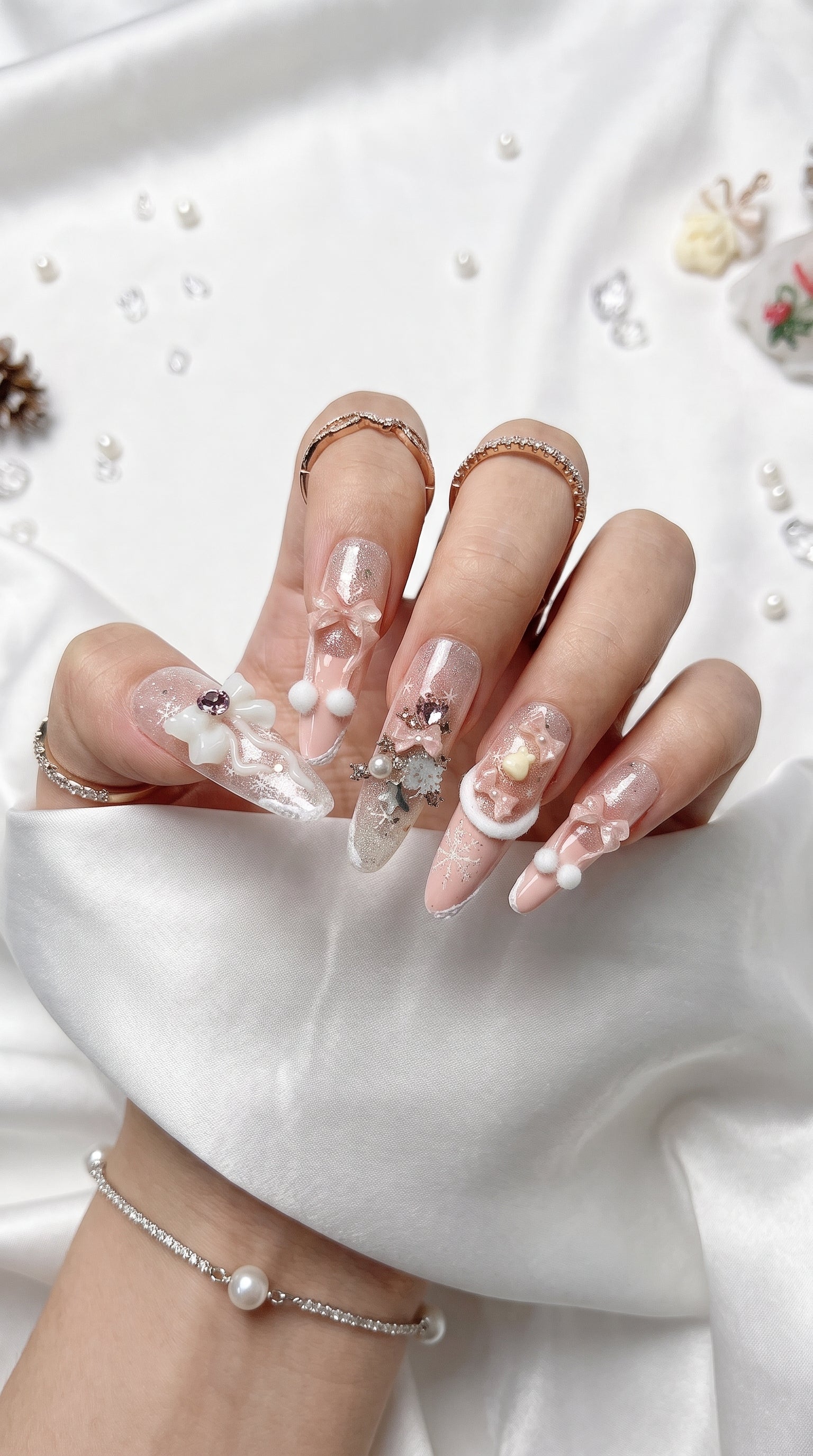 Long stiletto pink and white press-on nails worn on hand