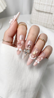 Long stiletto pink and white press-on nails worn on hand