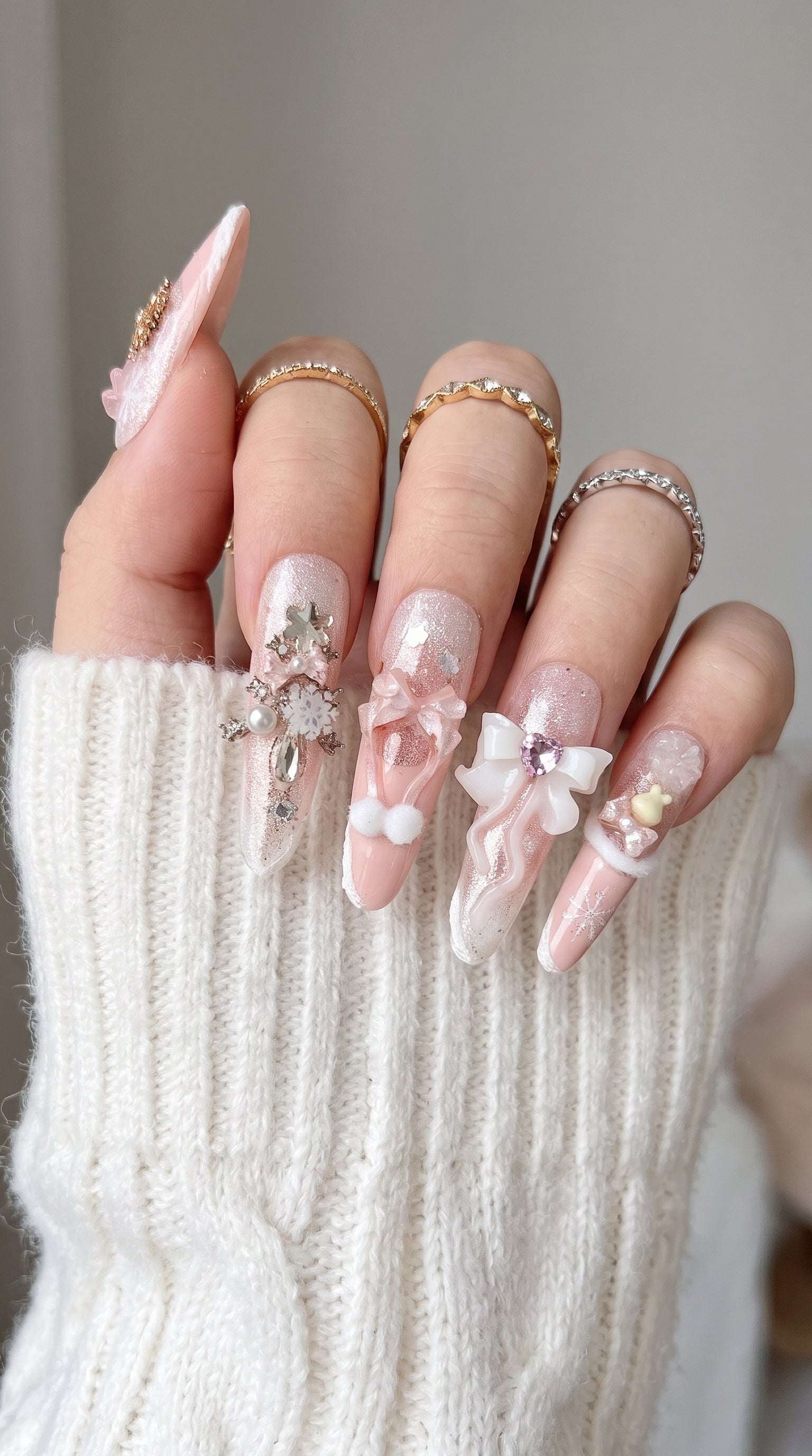 Long stiletto pink and white press-on nails worn on hand