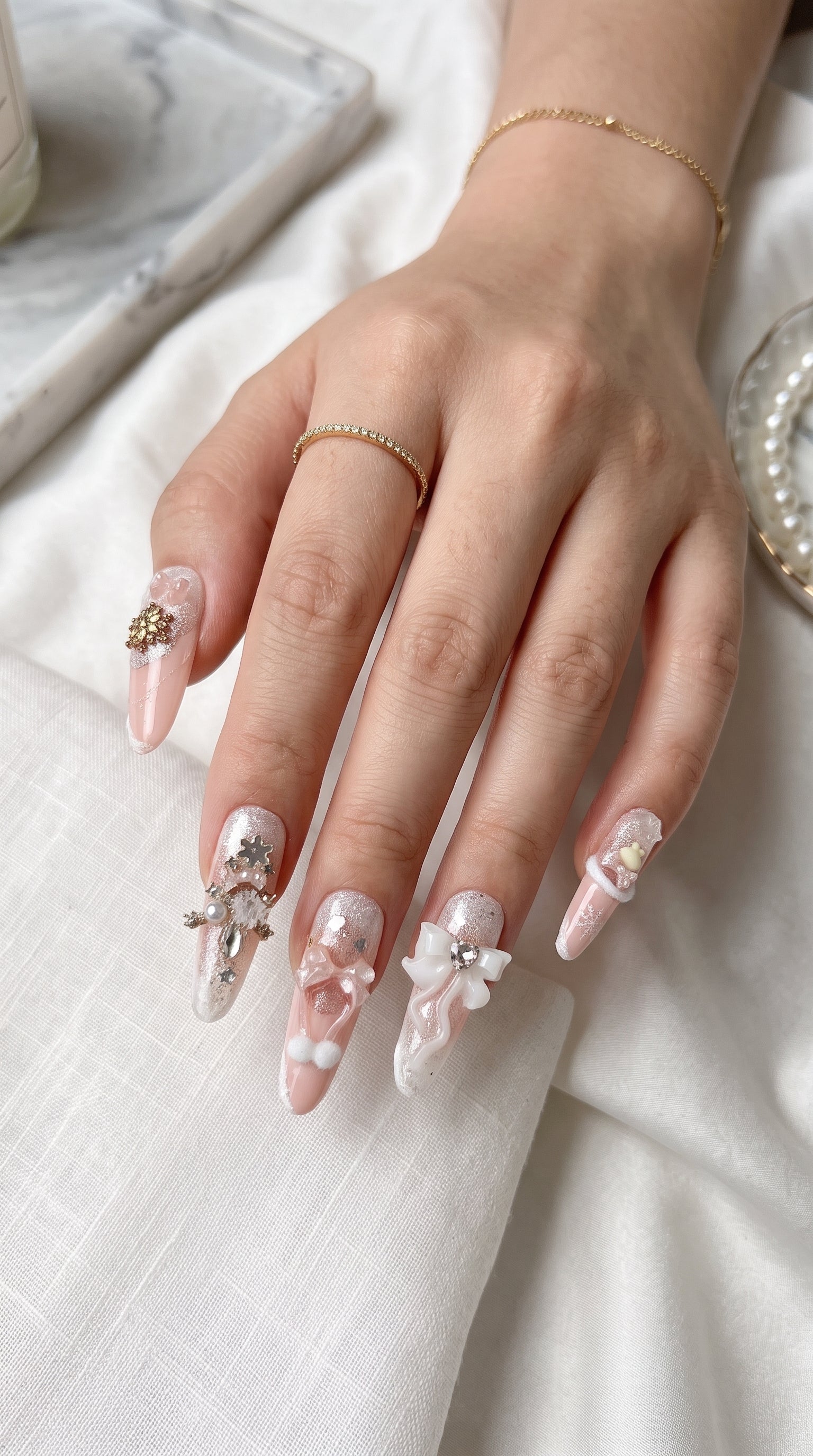 Long stiletto pink and white press-on nails worn on hand