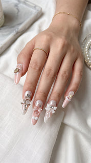 Long stiletto pink and white press-on nails worn on hand