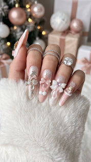 Long stiletto pink and white press-on nails worn on hand