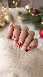 Cherry Ribbon Kiss red and nude pink press-on nails worn on hand, featuring long coffin nails with 3D cherries, pearl ribbon bows, plaid French tips, and sweet coquette nail art.