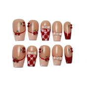 Cherry Ribbon Kiss long coffin press-on nail set featuring cherry red and nude pink French tips, 3D cherry charms, pearl bows, red-and-white plaid patterns, and glossy finishes.