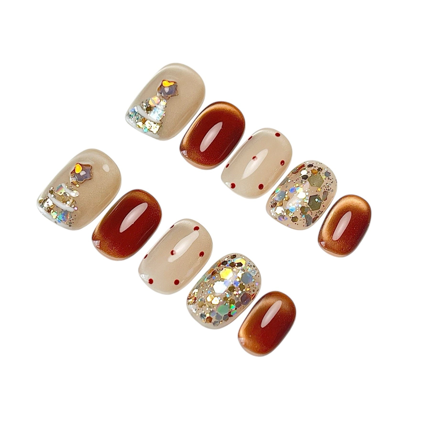 Cocoa & Twinkle short oval press-on nail set featuring metallic cocoa brown, creamy ivory, red polka dots, a sparkling Christmas tree design, and iridescent silver glitter accents.