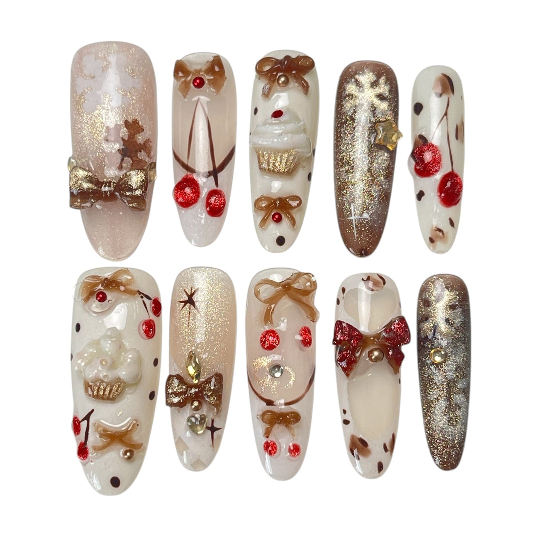 Gingerbread Wishes long almond press-on nail set featuring creamy ivory, champagne gold glitter, gingerbread-inspired nail art, 3D ribbon bows, red candy accents and sparkling stars.