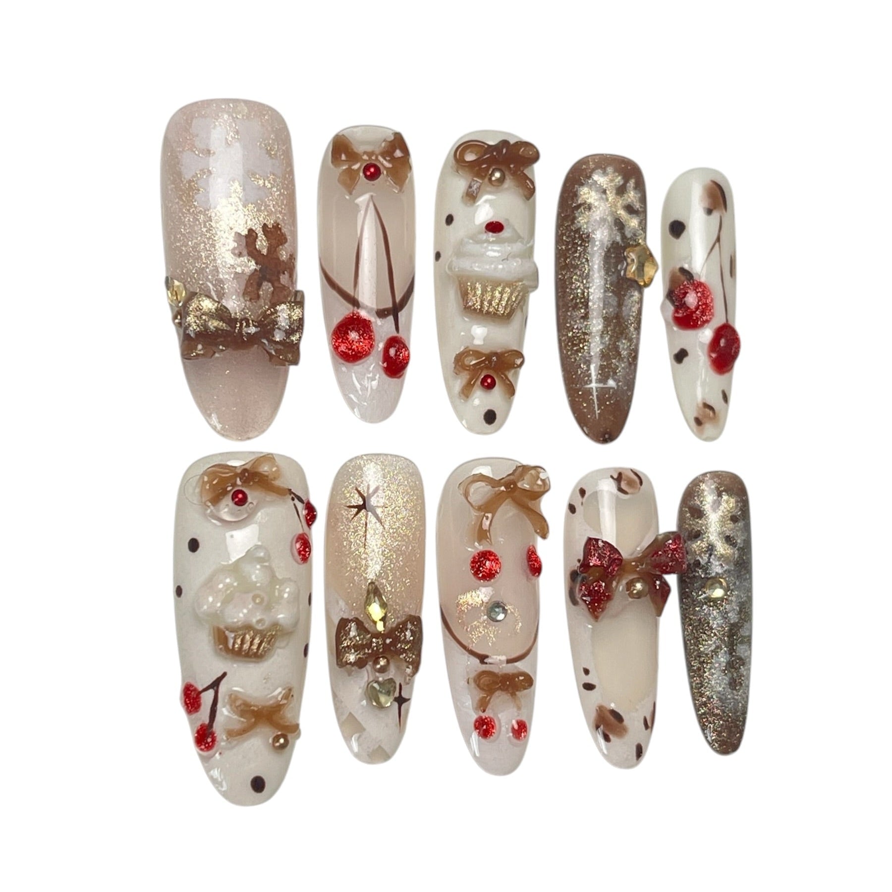 Gingerbread Wishes long almond press-on nail set featuring creamy ivory, champagne gold glitter, gingerbread-inspired nail art, 3D ribbon bows, red candy accents and sparkling stars.