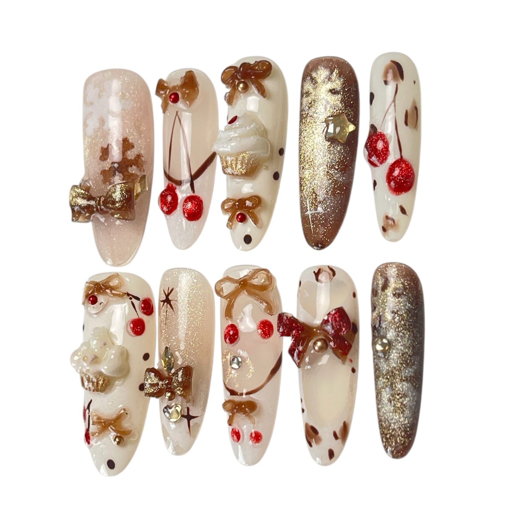 Gingerbread Wishes long almond press-on nail set featuring creamy ivory, champagne gold glitter, gingerbread-inspired nail art, 3D ribbon bows, red candy accents and sparkling stars.