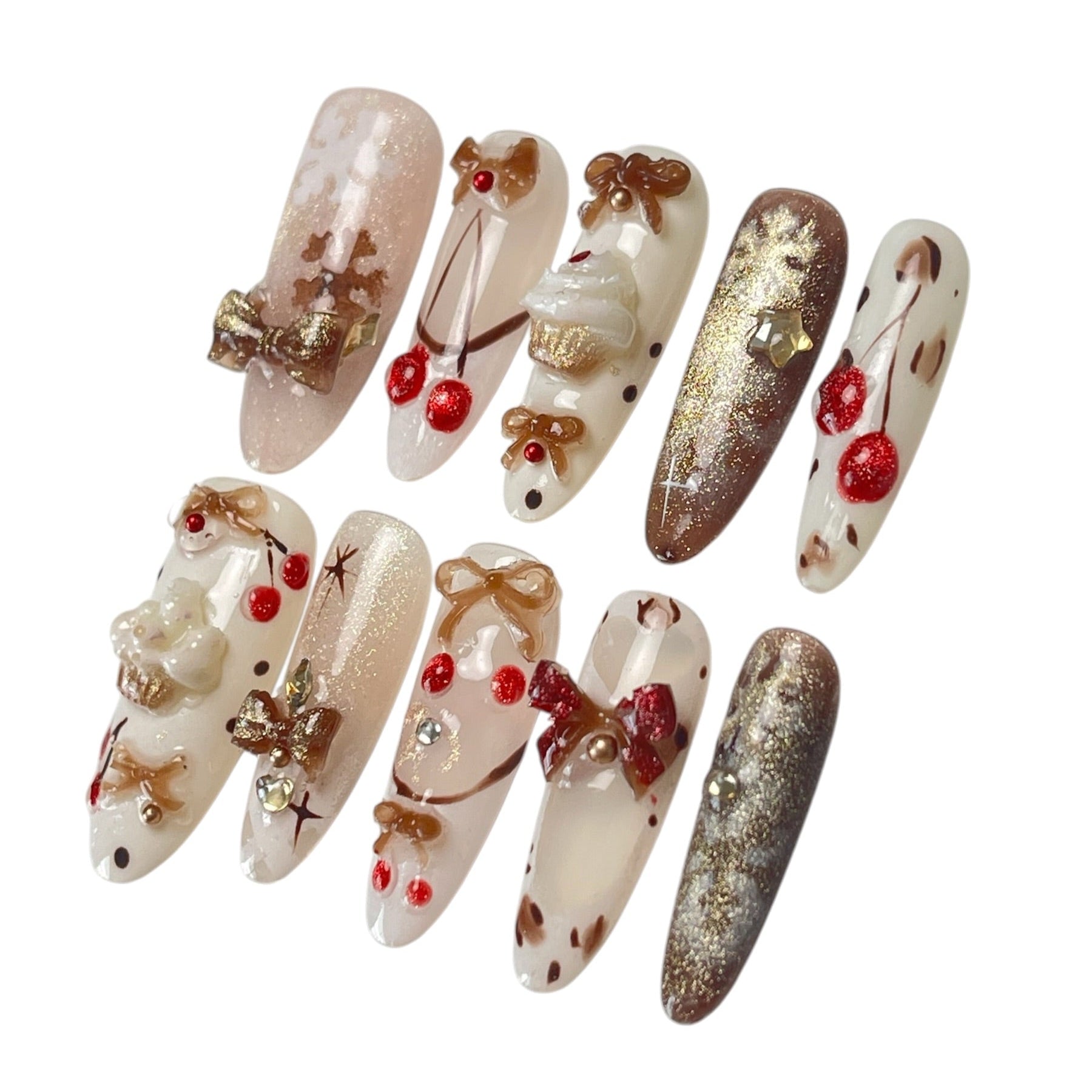 Gingerbread Wishes long almond press-on nail set featuring creamy ivory, champagne gold glitter, gingerbread-inspired nail art, 3D ribbon bows, red candy accents and sparkling stars.