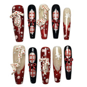 Midnight Candy Bows long coffin Christmas press-on nail set featuring glossy black, glittery red, 3D candy cane charms, red ribbon bows, plaid patterns and snowflake accents.