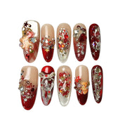 Ruby Teddy Treasures long coffin press-on nail set in ruby red, champagne gold and nude, featuring 3D teddy bear charms, metallic bows, hearts, pearls and sparkling crystals.