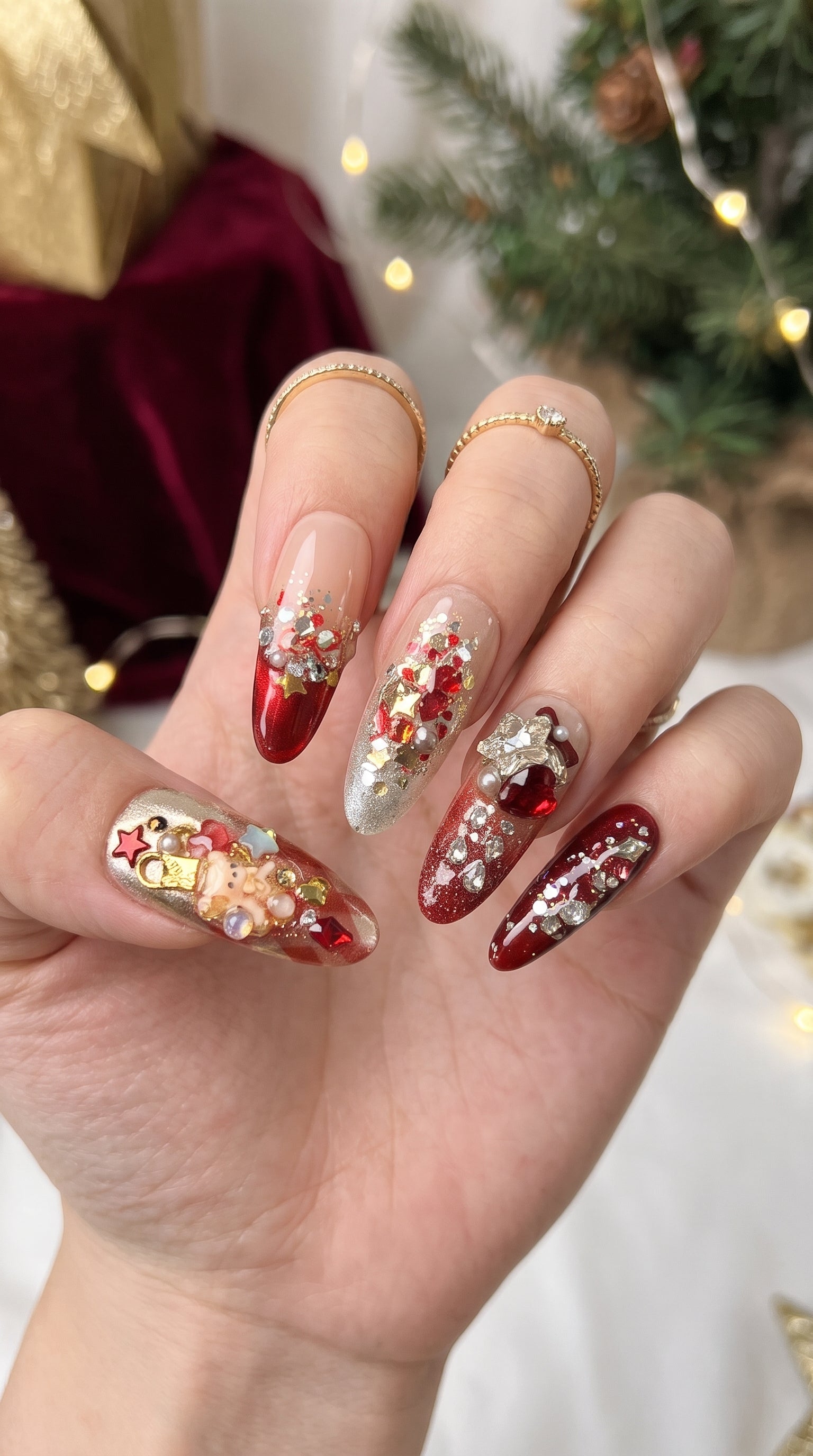 Ruby Teddy Treasures luxury press-on nails worn on hand, featuring long coffin nails with ruby red glitter, gold accents, 3D teddy bears, jeweled bows and pearl embellishments.