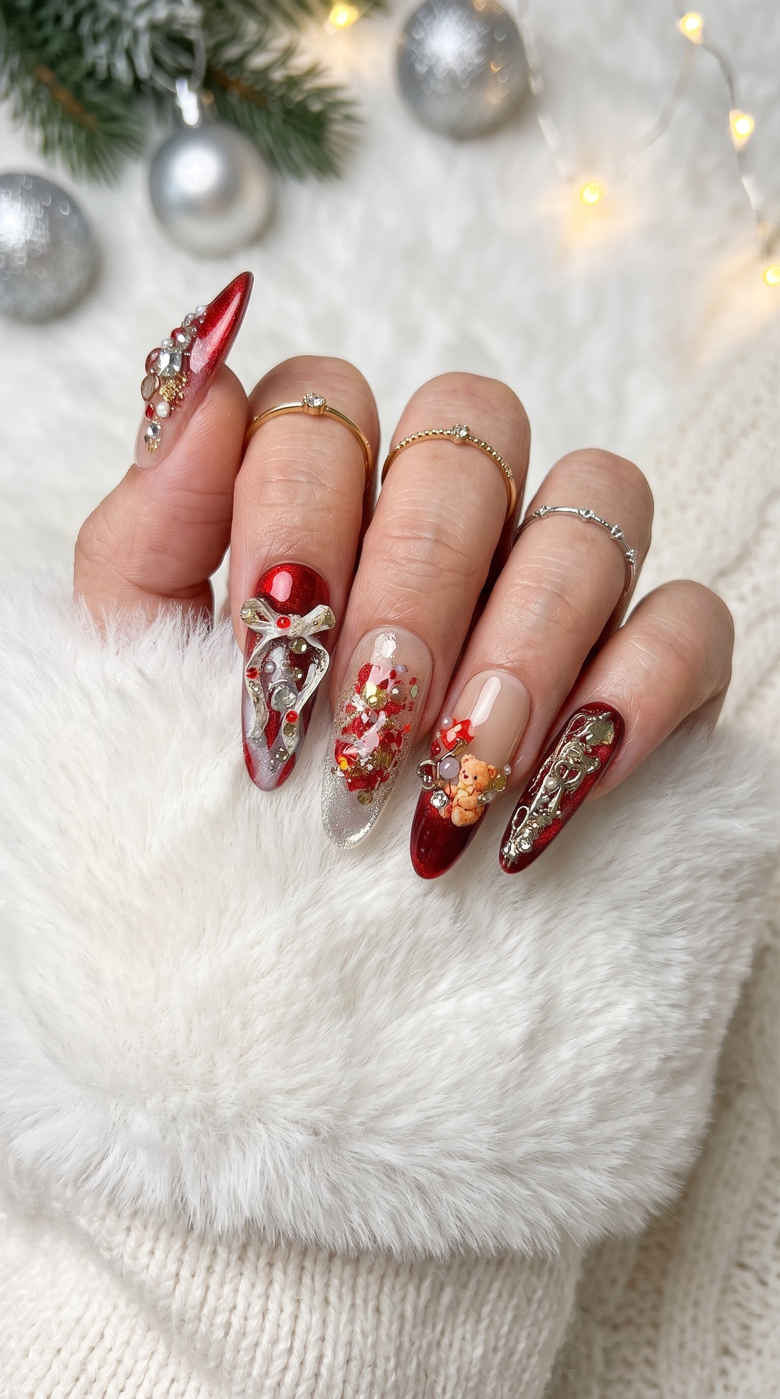 Ruby Teddy Treasures luxury press-on nails worn on hand, featuring long coffin nails with ruby red glitter, gold accents, 3D teddy bears, jeweled bows and pearl embellishments.